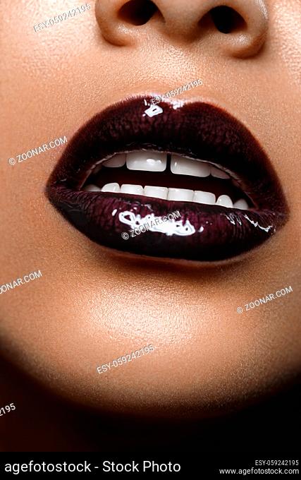 closeup shot of full sexy woman lips with black lipstick. copyspace