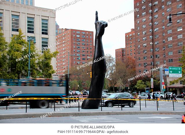12 November 2019, US, New York: The work ""Unity"" by the US artist Hank Willis Thomas. The sculpture consists of an almost seven-metre-high arm with a hand and...