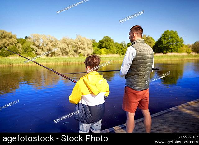 father and son fishing on river