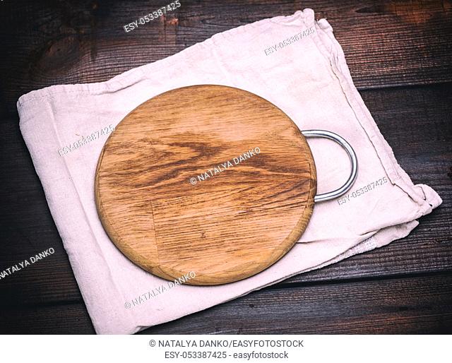 round wooden cutting board on a gray napkin, vintage toning