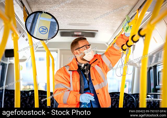 22 April 2020, Berlin: An employee cleans the passenger area of a BVG bus at the terminal stop Kurt-Schumacher-Platz. Teams of two to three employees clean up...