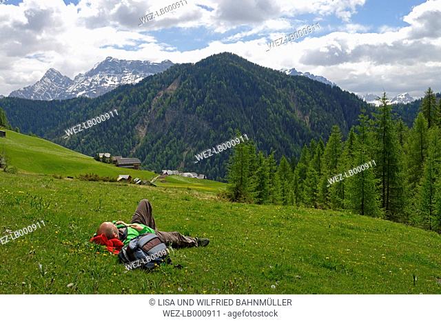 Italy, Alto Adige, man resting in the Campill valley