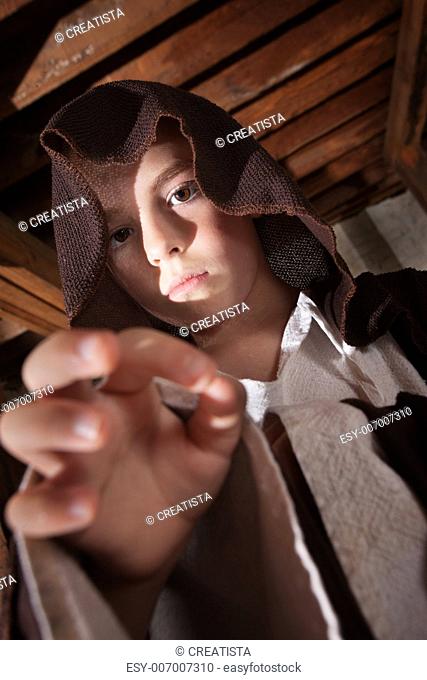 Young boy dressed as a science fiction character reaching out