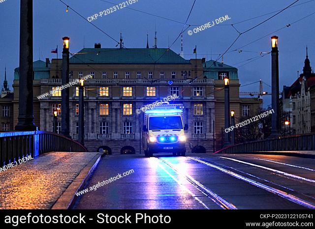 A police officer patrols closed Manes Bridge heading towards Jan Palach Square, where shots were fired in the Faculty of Arts building, in Prague