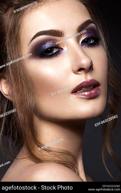 Beautiful girl with perfect skin, colorful make-up, evening hairstyle. .Beauty face. Picture taken in the studio