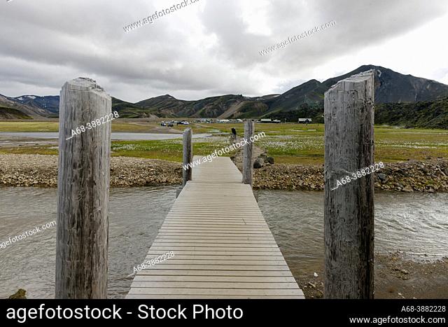 Landscape in Iceland, Landmannalaugar Camping and Tourist Information Center. Footbridge crosses a watercourse
