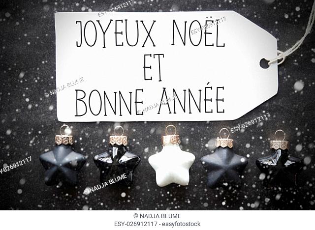 Label With French Text Joyeux Noel Et Bonne Annee Means Merry Christmas And Happy New Year. Black And White Christmas Tree Balls On Black Paper Background With...