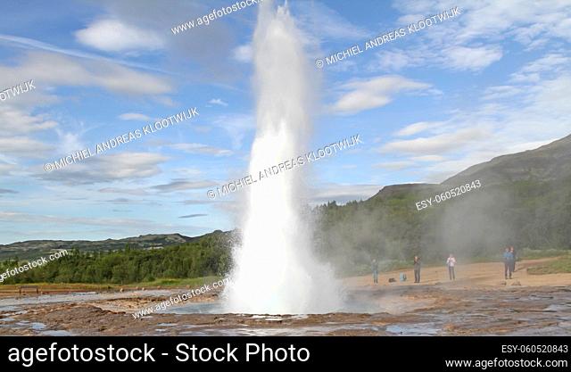 Geysir, Iceland - July 28, 2021: Geyser Strokkur in iceland errupting with hot water and steam, each year many tourists visit the geyser located in the golden...