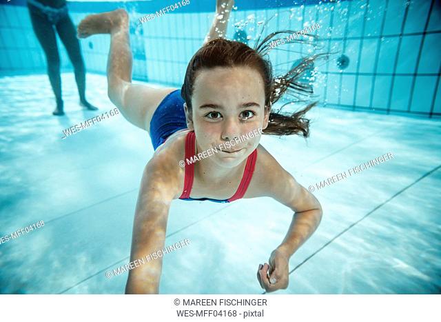 Portrait of girl under water in swimming pool