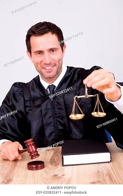 Male Judge Holding Scale