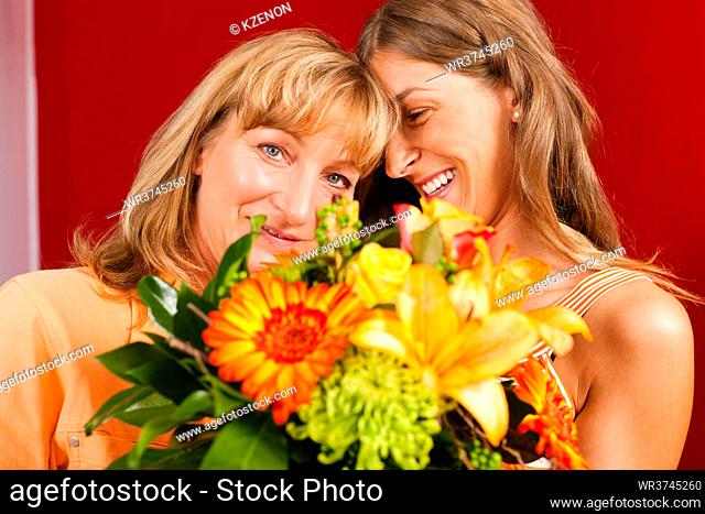 Mother and daughter - the daughter has given her mother flowers