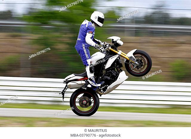 Motorcycle, Triumph Speedtriple R, year of construction in 2012, naked bike, race course, Wheelie
