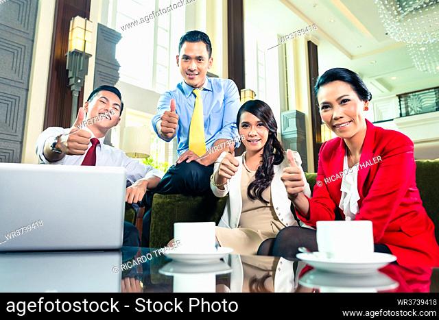 Asian Businesspeople showing thumbs up