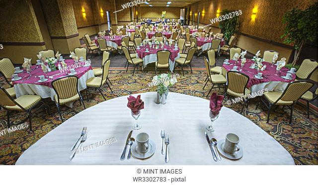 Place settings on tables in banquet room