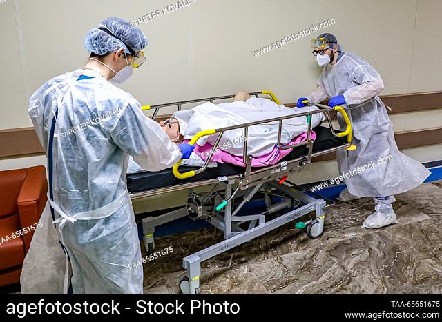 RUSSIA, ST PETERSBURG - DECEMBER 11, 2023: Medical workers attend move a COVID-19 ward patient on a gurney at St George City Hospital