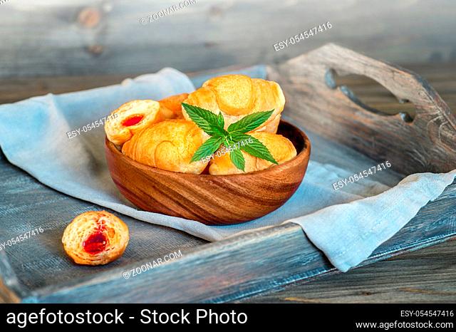 Croissants on a wooden tray. The concept of a wholesome breakfast