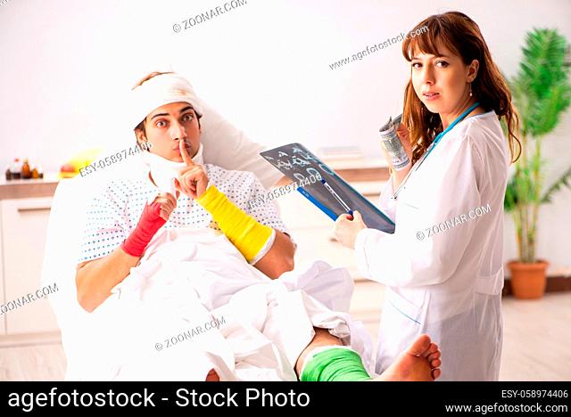 Young doctor examining injured patient