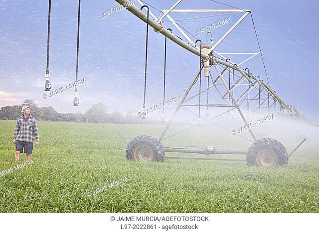 A farmer inspects his center pivot irrigation system, Victoria Australia