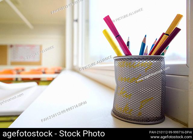 12 January 2021, Saxony-Anhalt, Gardelegen: Pencils stand in a cup on the windowsill in an unused classroom at Karl Marx Secondary School