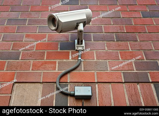 cctv security video camera on outside wall of a building