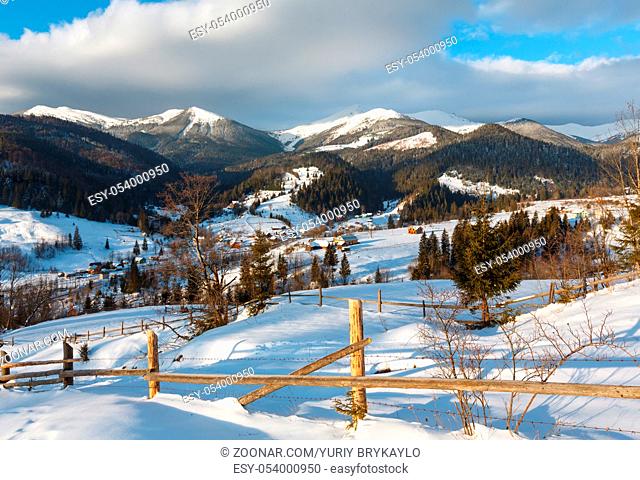 Winter morning scenery tranquility peaceful mountain Dzembronya village outskirts hills and view to picturesque Chornohora alp ridge (Ukraine