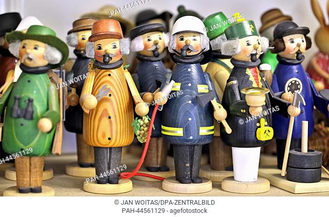 Smoking men in various jobs stand in the Kuhnert turnery workshop in Rothenkirchen,  Germany, 26 November 2013. Nutcrackers, miners and angels were yesterday