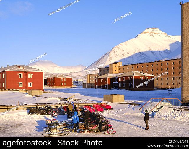 Snowmobiles and visitors. Pyramiden, abandoned russian mining settlement at the Billefjorden, island Spitzbergen in the svalbard archipelago