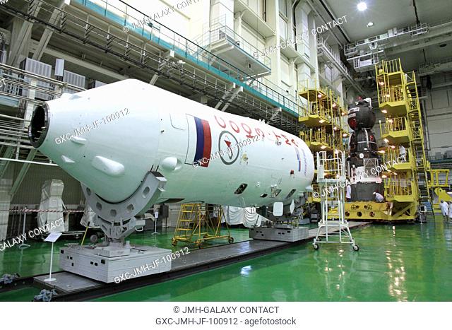 At the Baikonur Cosmodrome in Kazakhstan, the Soyuz TMA-04M spacecraft (background) and its Soyuz booster upper stage (foreground) stand poised in their...
