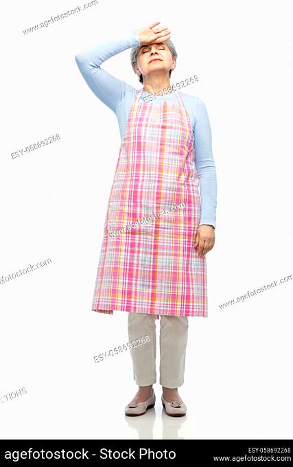 tired senior woman in apron