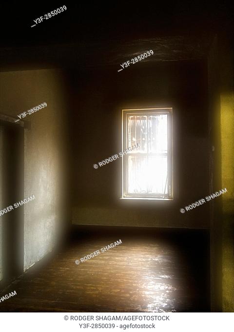 Interior of an old, empty house, grimy sash window, oregon pine floors, eerie light