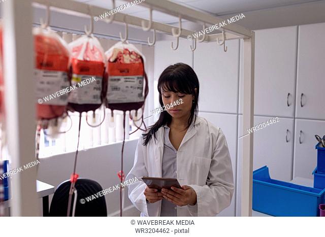 Laboratory technician using digital tablet