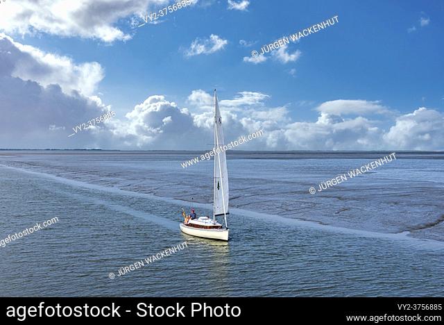 Benser Aussenentief with sailing boat while entering the harbor, Bensersiel, Germany, Lower Saxony, Europe