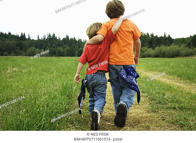 Two brothers walking in field