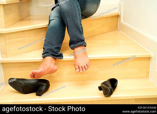 Asian business woman pain ankle, foot with leg cramp and fall down the stairs because slippery surfaces in office