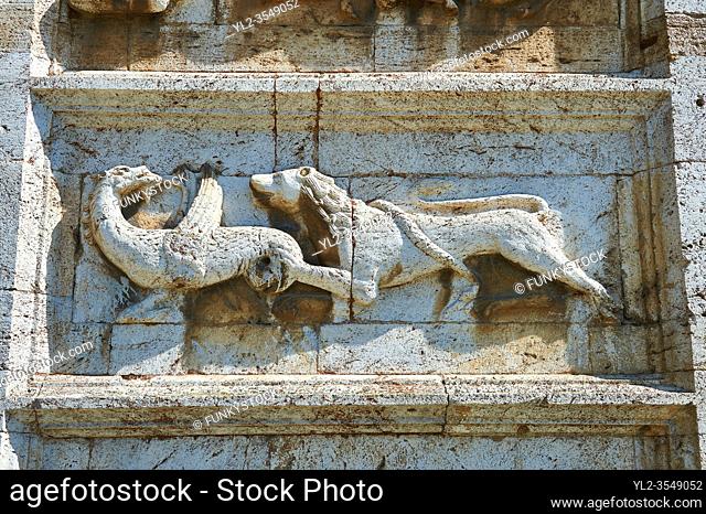 Sculpture of a lion and a griffen on the 12th century Romanesque facade of the Chiesa di San Pietro extra moenia (St Peters), Spoletto, Italy