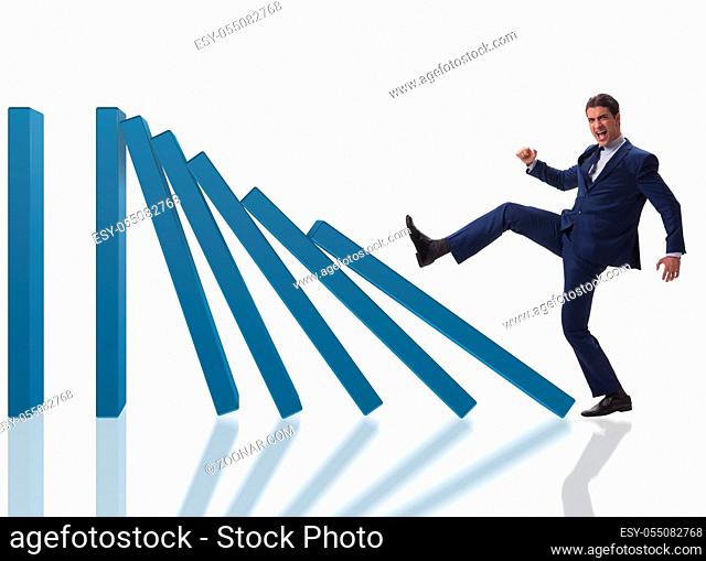 The businessman in domino effect business concept