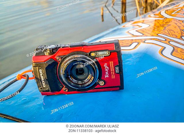 Fort Collins, CO, USA - October 23, 2017: Compact, waterproof Olympus Stylus Tough TG-5 camera on a wet deck of a stand up paddleboard by Starboard