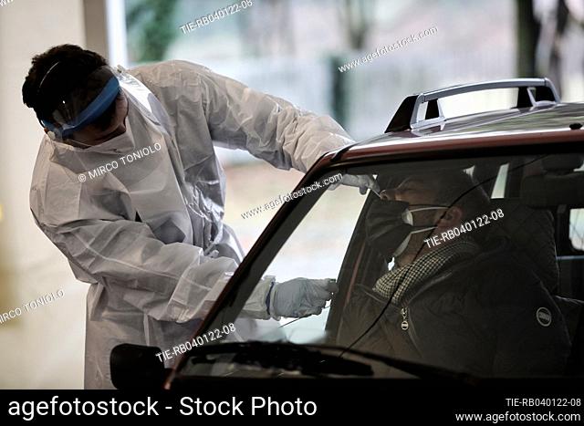 Medical worker collects a swab sample Covid-19 drive-through at the Hub of Piazzale Giustiniani in Mestre , ITALY-04-01-2022