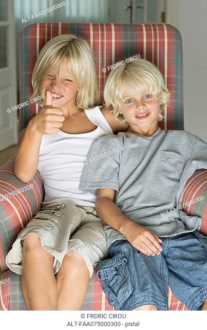 Brothers sitting in armchair, portrait