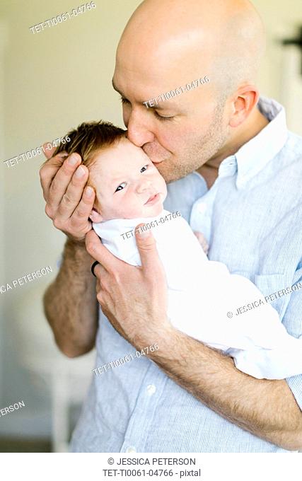 Man kissing his baby son