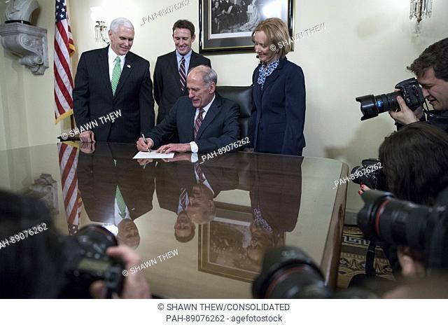Director of National Intelligence Dan Coats (2-R), with his wife Marsha Coats (R), family members and United States Vice President Mike Pence (L)