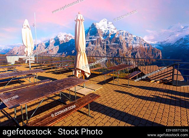 Grindelwald, Switzerland, Jungfraujoch sunset panorama, bar terrace at First peak of Swiss Alps mountain, snow peaks