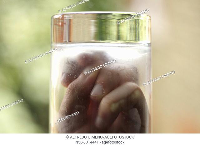 hand in a frozen glass
