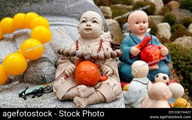 Closeup view of statues of religious monks. Buddha mini statue with beautiful background
