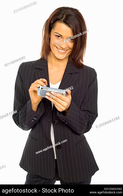 Formalwear woman standing and smiling at camera. She's holding pocket pc and pen. Isolated on white in studio