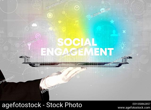 Waiter serving social networking with SOCIAL ENGAGEMENT inscription, new media concept