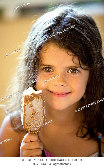 Little girl showing her ice cream satisfied