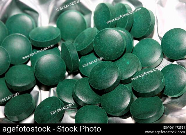 Medical green round vitamins spirulina platensis healthy super food close up background high quality big size prints