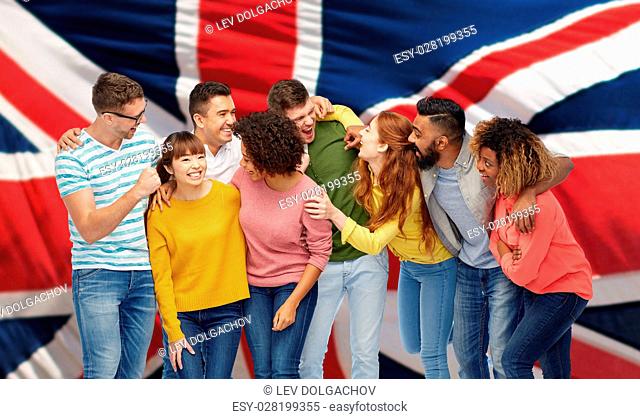 diversity, race, ethnicity and people concept - international group of happy men and women laughing over english flag background