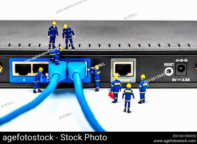 Group of engineers connecting fiber network cables. Macro photo